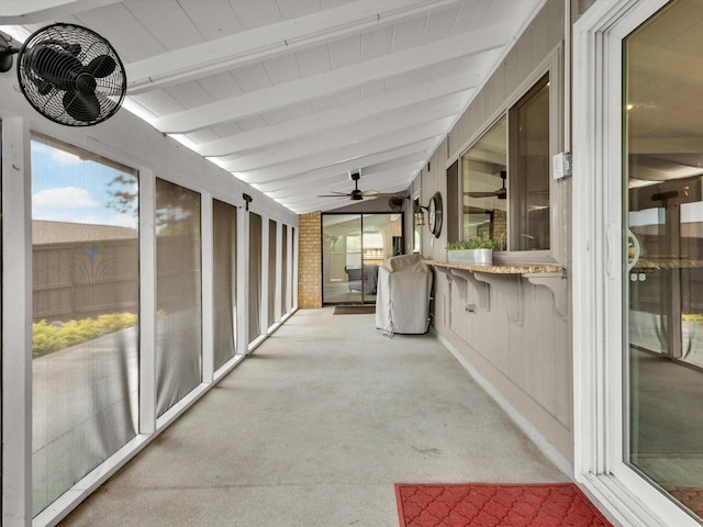 exterior space featuring ceiling fan, beamed ceiling, and carpet floors