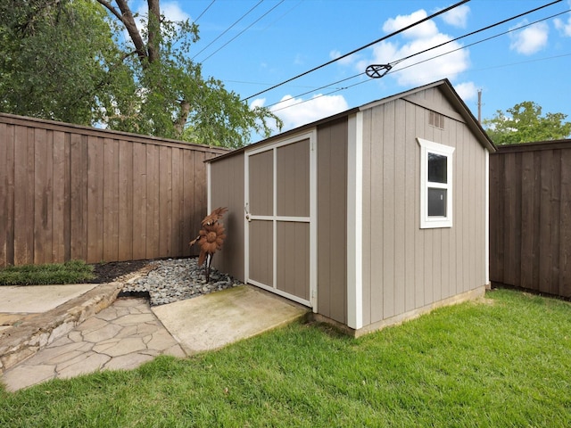 view of shed with a fenced backyard