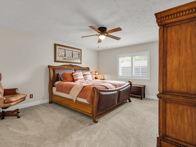 bedroom with light colored carpet, a ceiling fan, and baseboards