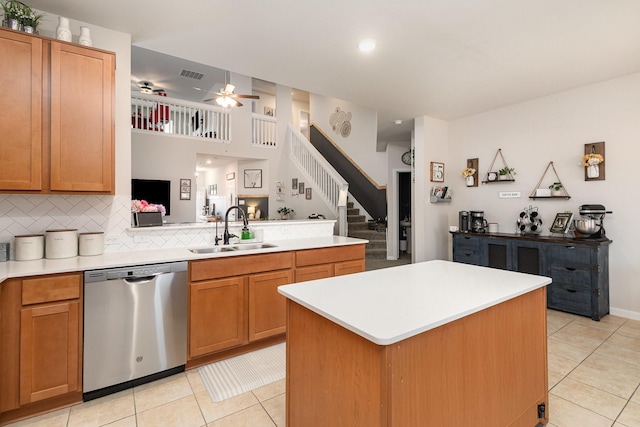 kitchen featuring visible vents, stainless steel dishwasher, light tile patterned flooring, and a sink