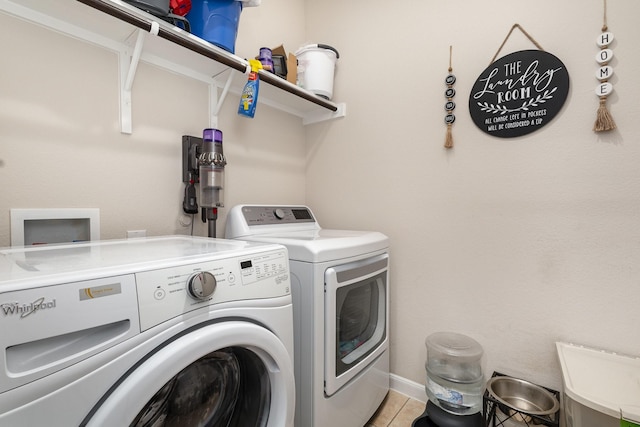 laundry area with light tile patterned flooring, separate washer and dryer, and laundry area