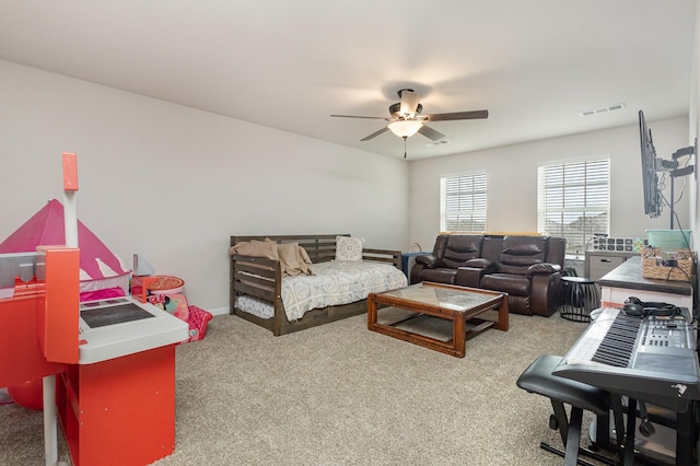 carpeted living area featuring ceiling fan and visible vents