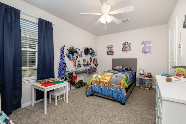 carpeted bedroom with baseboards, visible vents, and ceiling fan