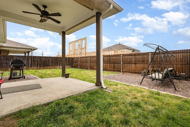 view of yard featuring a patio, a fenced backyard, and a ceiling fan