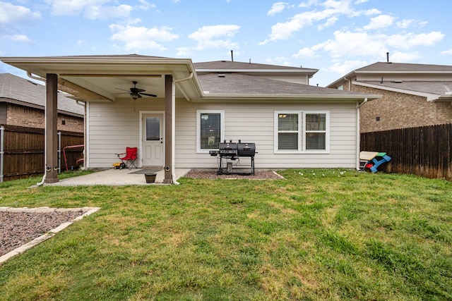 rear view of property with ceiling fan, a yard, a patio, and a fenced backyard