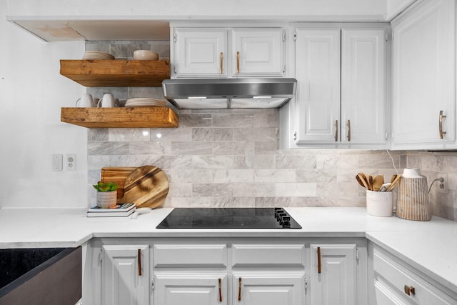 kitchen with white cabinets, ventilation hood, black electric stovetop, and light countertops