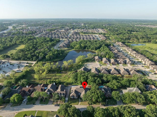 birds eye view of property with a water view and a residential view