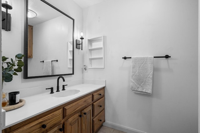 bathroom with baseboards and vanity