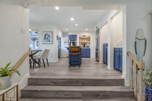interior space with ornamental molding, recessed lighting, light wood-style flooring, and baseboards