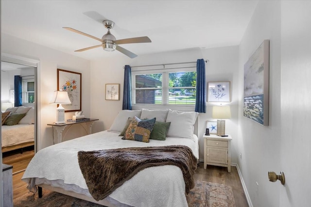 bedroom with wood finished floors, ceiling fan, and baseboards