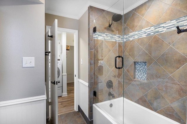 full bath featuring ornamental molding, tiled shower / bath combo, and washer / clothes dryer