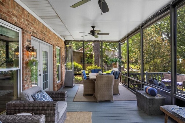 sunroom / solarium featuring outdoor dining space, ceiling fan, and a wealth of natural light