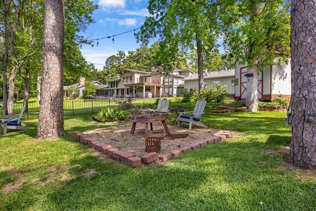 view of yard with a fire pit and fence