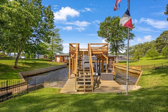 view of playground with a lawn, fence, and a water view