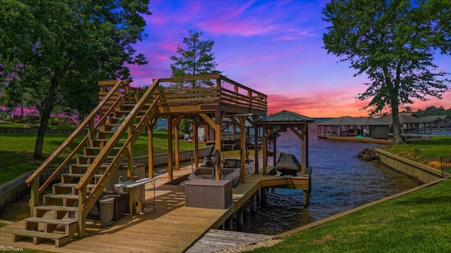 view of dock featuring a yard, a water view, stairway, and boat lift