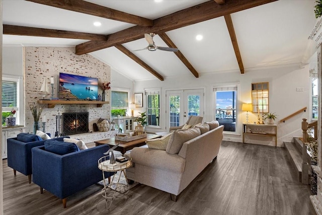 living area with a fireplace, lofted ceiling with beams, ceiling fan, and dark wood-type flooring