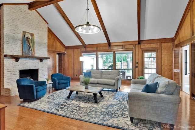 living room featuring high vaulted ceiling, a chandelier, wood finished floors, beam ceiling, and wooden walls
