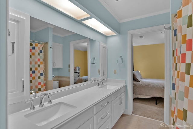 ensuite bathroom with ornamental molding, tile patterned flooring, double vanity, and curtained shower