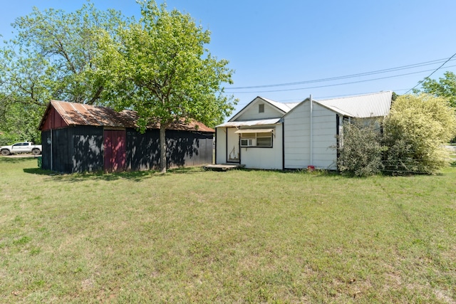 back of property featuring a lawn