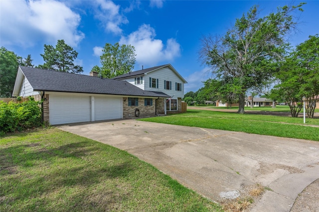 2820 Bois D Arc St, Commerce, TX 75428 - traditional-style house with a garage, driveway, a front yard, a chimney, and brick siding