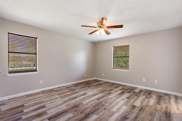 2820 Bois D Arc St, Commerce, TX 75428 - empty room featuring ceiling fan, wood finished floors, baseboards, and a textured ceiling