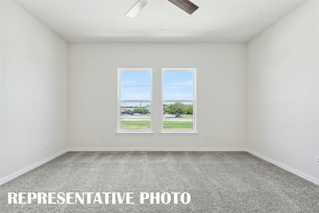 spare room with baseboards, ceiling fan, and carpet flooring