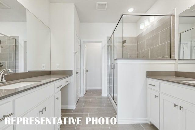 bathroom with visible vents, a stall shower, two vanities, and a sink