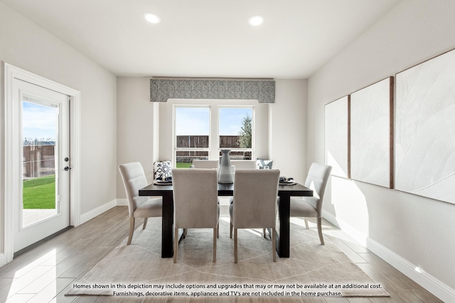 dining room with recessed lighting, light wood finished floors, and baseboards