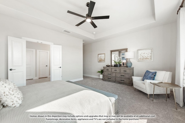 bedroom with carpet flooring, a raised ceiling, visible vents, baseboards, and a ceiling fan