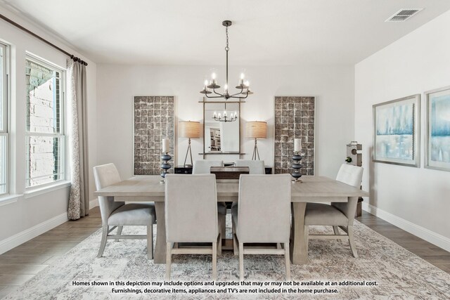 dining space with a wealth of natural light, wood finished floors, and a notable chandelier