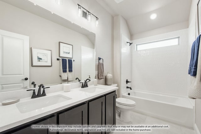 full bathroom featuring toilet, double vanity, a sink, and shower / bathing tub combination