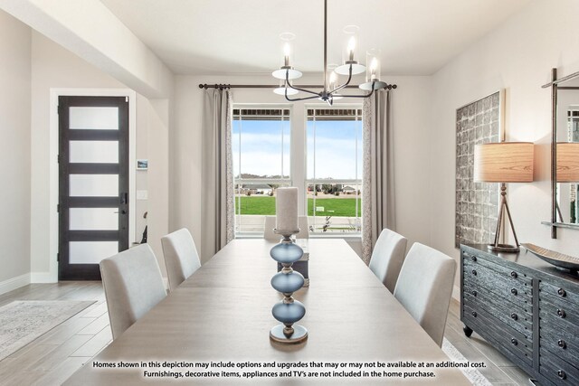 dining room with baseboards, wood finished floors, and an inviting chandelier