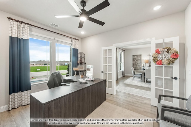 office space with a ceiling fan, visible vents, light wood-style flooring, and french doors