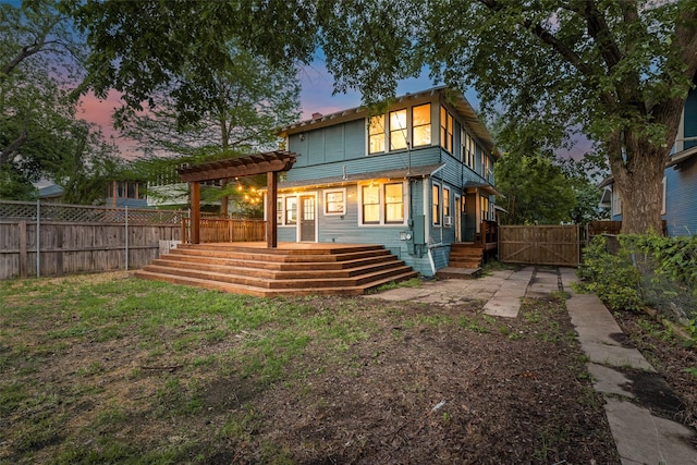 123 S Rosemont Ave, Dallas, TX 75208 - back of house at dusk featuring a pergola, a wooden deck, and a gate