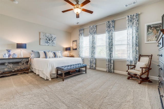 carpeted bedroom featuring lofted ceiling, visible vents, ceiling fan, and baseboards