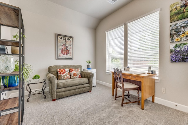 carpeted office with lofted ceiling and baseboards