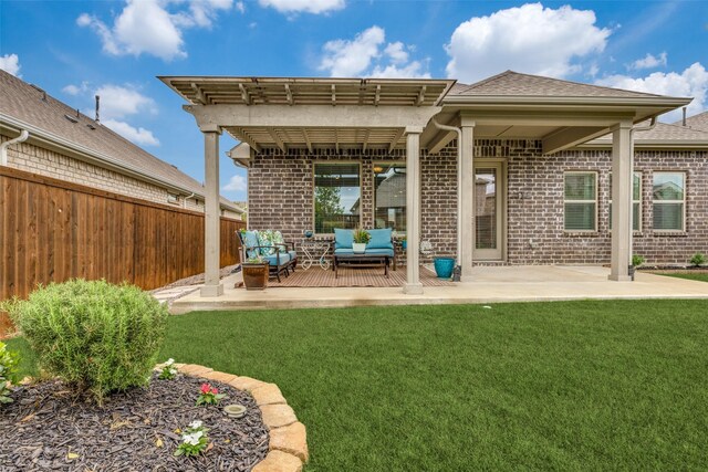 back of property featuring fence, a lawn, brick siding, and an outdoor living space