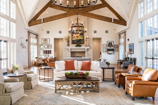 living area with a chandelier, a healthy amount of sunlight, and high vaulted ceiling