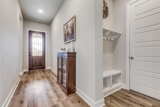 mudroom featuring visible vents, wood finished floors, and baseboards