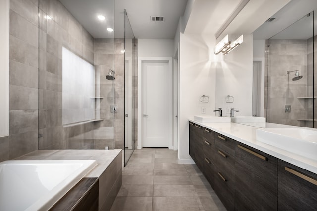 bathroom with a sink, double vanity, visible vents, and a shower stall
