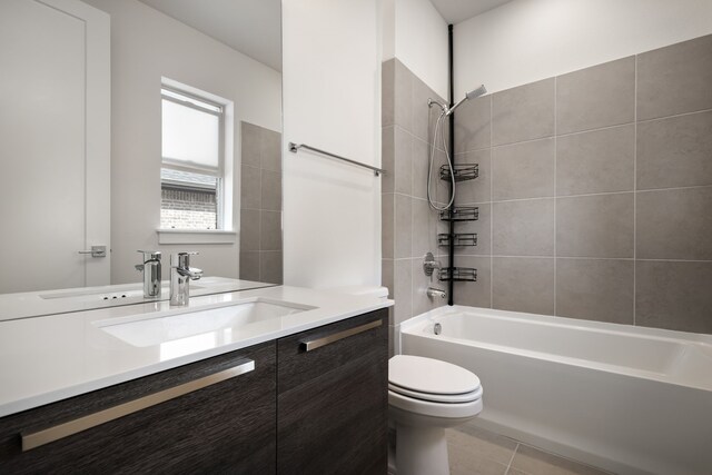 bathroom with toilet, vanity,  shower combination, and tile patterned flooring