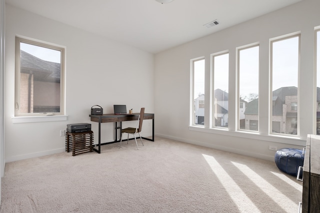 office area featuring visible vents, carpet flooring, and baseboards