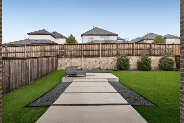 view of yard featuring a patio and a fenced backyard