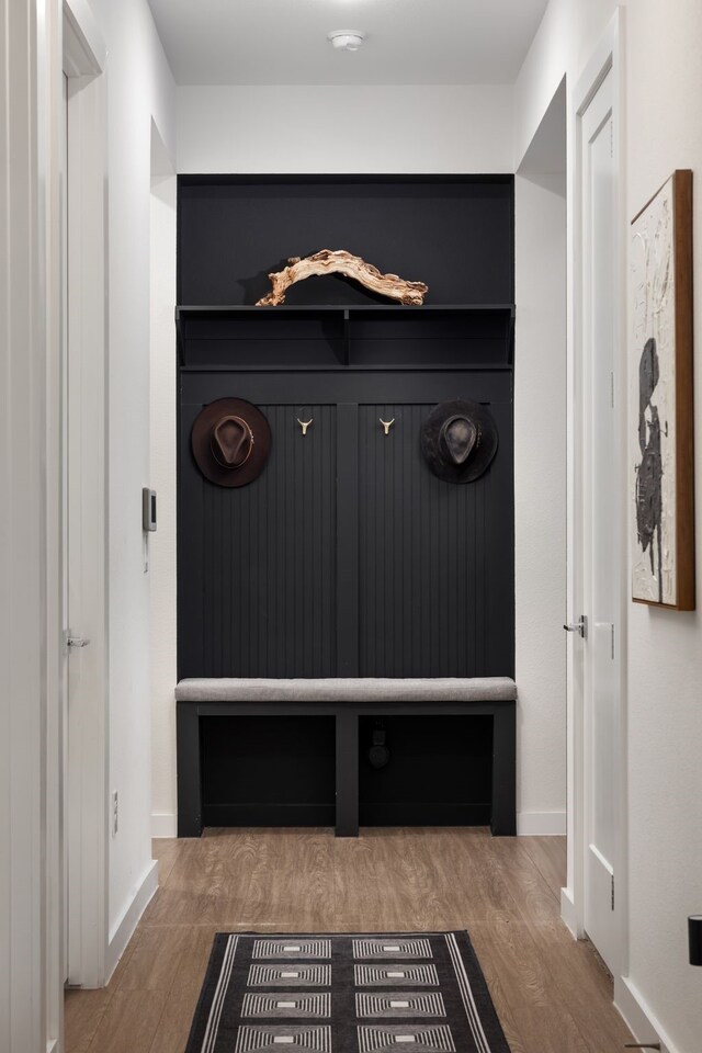 mudroom with wood finished floors and baseboards