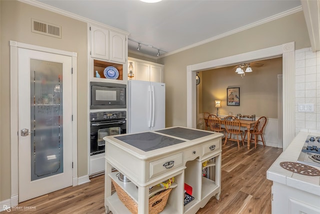 kitchen featuring visible vents, open shelves, black appliances, light wood finished floors, and white cabinetry