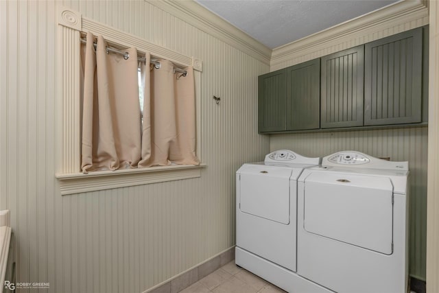 laundry area with light tile patterned floors, baseboards, cabinet space, and independent washer and dryer