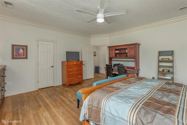 bedroom featuring visible vents, ornamental molding, baseboards, and light wood-type flooring