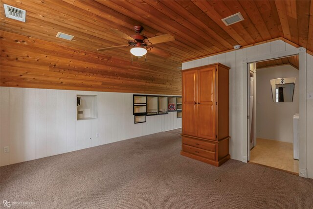 interior space featuring carpet flooring, a ceiling fan, visible vents, and wooden ceiling