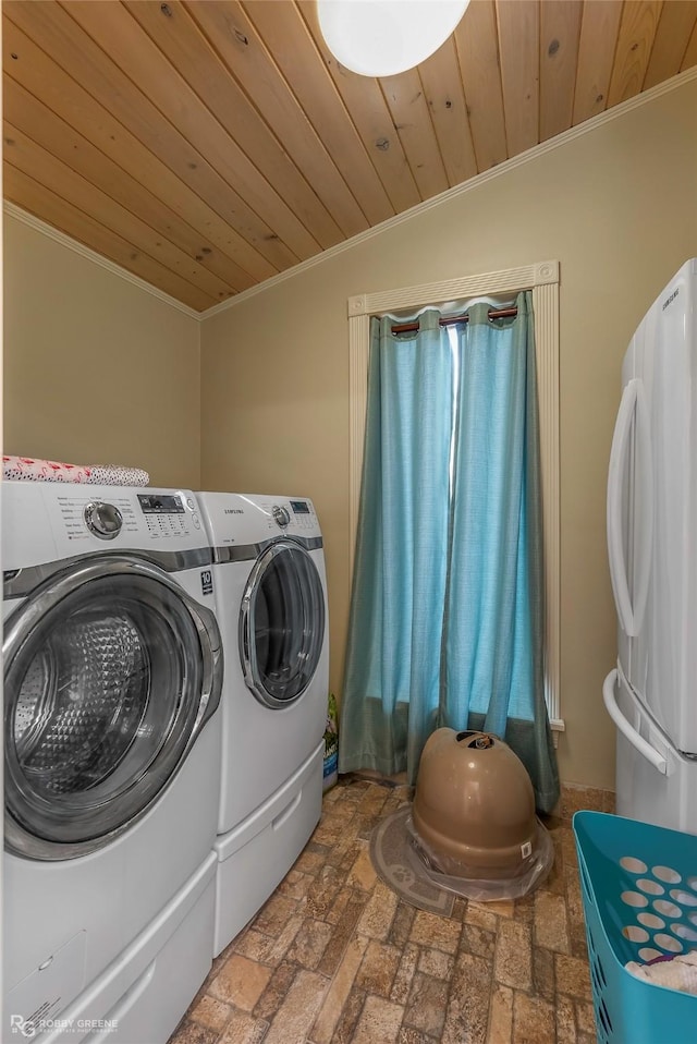 washroom featuring washer and dryer, crown molding, wood ceiling, and laundry area