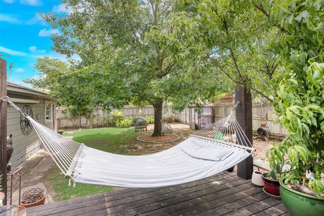 wooden terrace featuring a fenced backyard